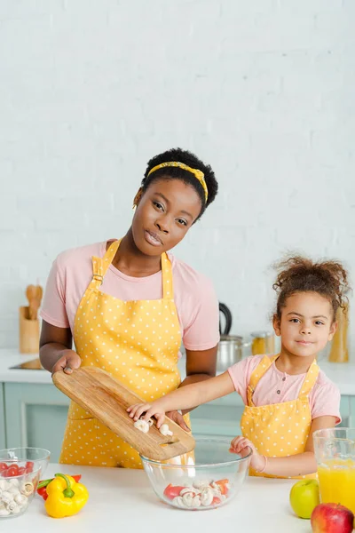 Cheerful African American Mother Holding Cutting Board Bowl Cute Daughter — ストック写真