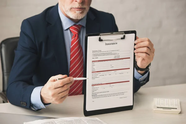 Cropped View Bearded Agent Holding Pen Clipboard Insurance Lettering Office — Stock Photo, Image