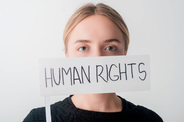 young woman holding flag with human rights lettering isolated on white