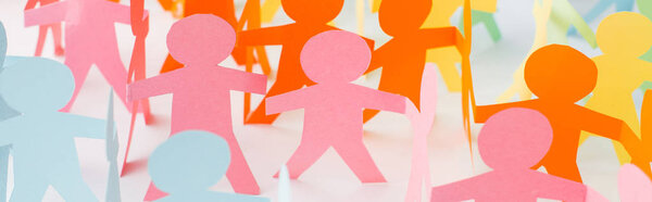 panoramic shot of colorful paper cut chain people on white, human rights concept 