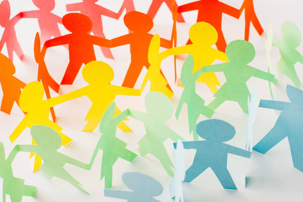 colorful paper cut connected people on white, human rights concept 