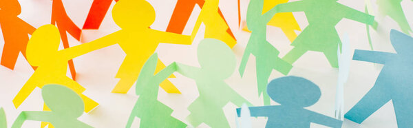 panoramic shot of colorful paper cut connected people on white, human rights concept 