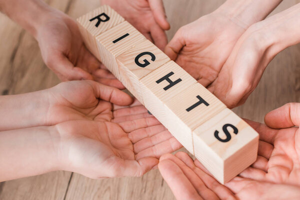 cropped view of group holding wooden cubes with rights lettering 