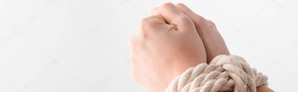 panoramic shot of woman with tied hands isolated on white, human rights concept 