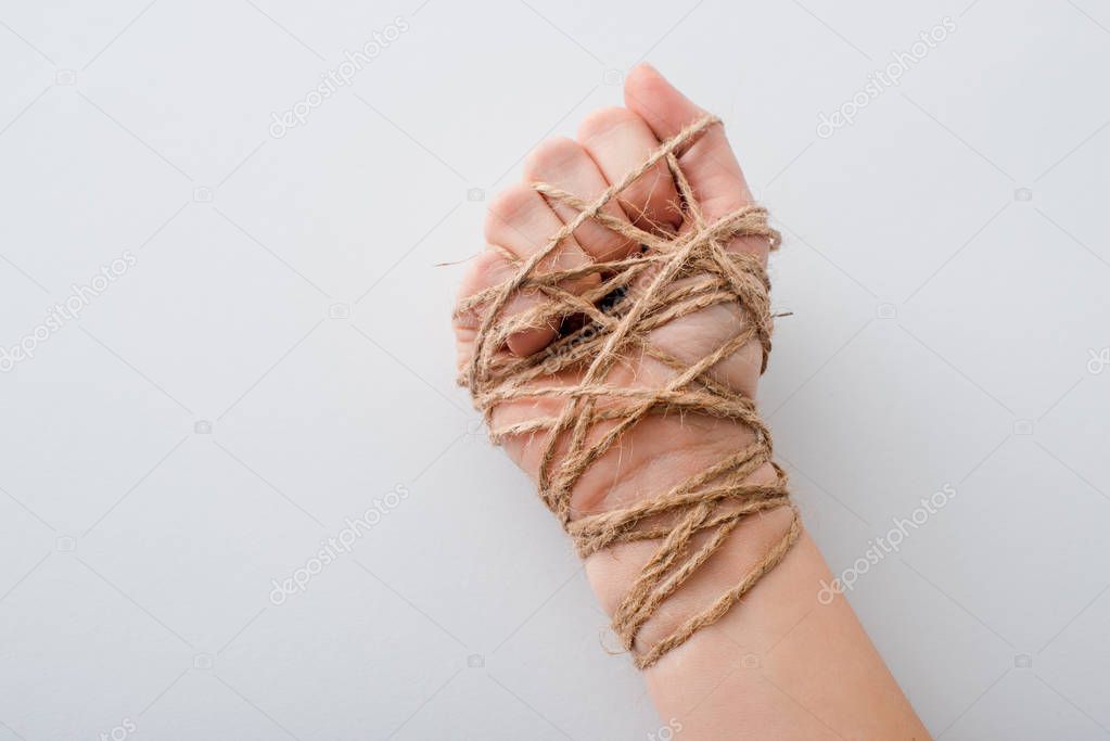 cropped view of girl with tied hand isolated on white, human rights concept 