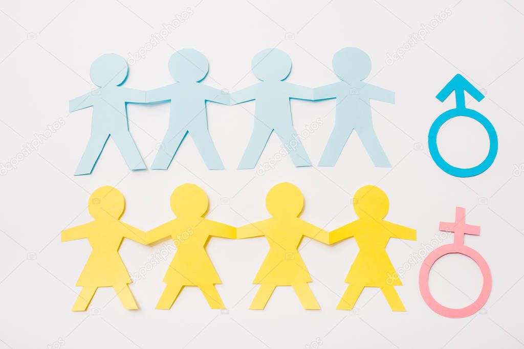 top view of paper cut connected people near gender signs isolated on white, sexual equality concept 