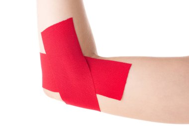 Cropped view of kinesiology tapes on female cubit isolated on white clipart