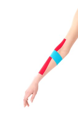 Cropped view of kinesiology tapes on woman hand isolated on white clipart