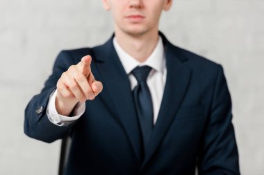 cropped view of realtor pointing with finger isolated on white, leasing concept 