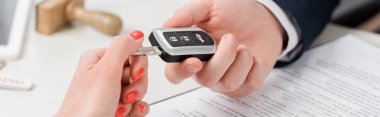 panoramic shot of realtor giving key to woman, leasing concept