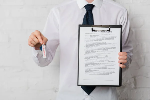 Cropped View Realtor Suit Holding Key Clipboard Lease Agreement White — Stockfoto