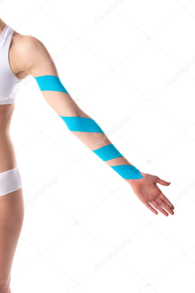 Cropped view of kinesiology tapes on hand on young woman isolated on white