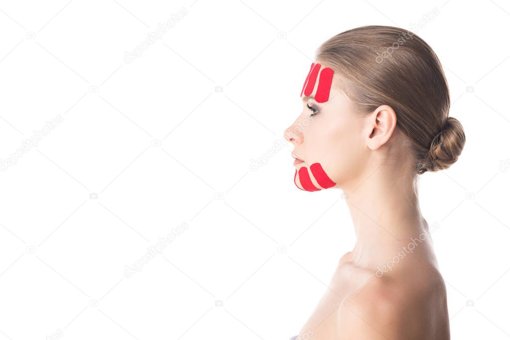 Side view of kinesiology tapes on chin and forehead of beautiful girl isolated on white