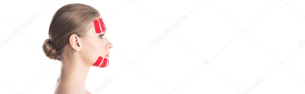 Side view of kinesiology tapes on face of beautiful woman isolated on white, panoramic shot