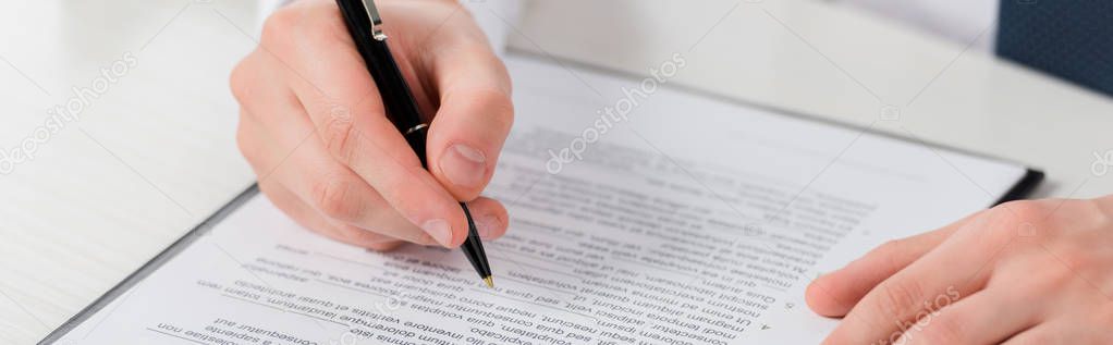 panoramic shot of businessman holding pen near clipboard with document, leasing concept 