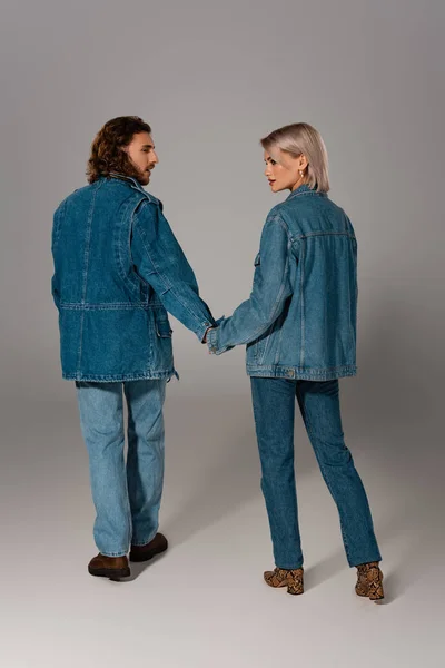 Back View Stylish Man Woman Denim Jackets Holding Hands Grey — Stock Photo, Image