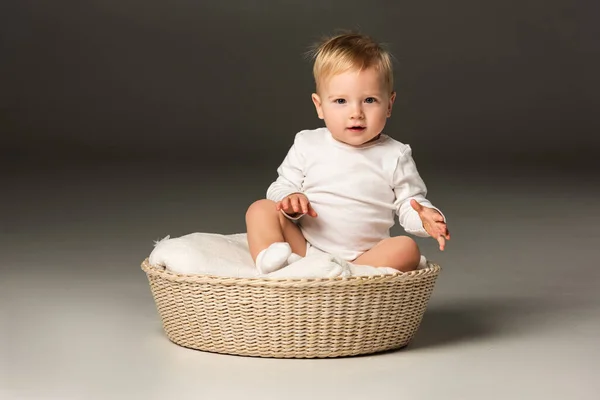 Cute Child Looking Camera Sitting Blanket Basket Black Background — Stock Photo, Image