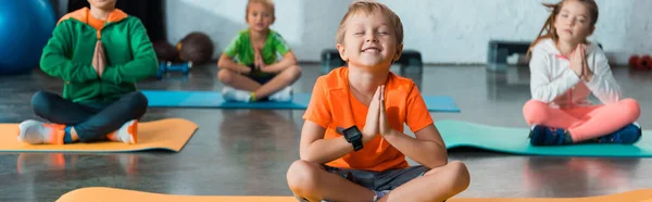 Selective Focus Children Clenched Hands Crossed Legs Fitness Mats Panoramic — Stock Photo, Image