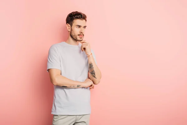 Handsome Pensive Man Looking Away Touching Chin Pink Background — Stock Photo, Image
