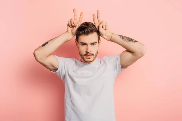 Offended Young Man Showing Horns Gesture While Looking Camera Pink — Stock Photo, Image