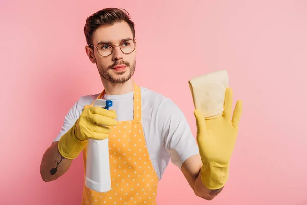Serious Young Man Apron Rubber Gloves Holding Spray Bottle Rag — Stock Photo, Image