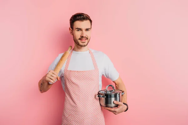 Cheerful Young Man Apron Holding Saucepan Rolling Pin Pink Background — Stock Photo, Image
