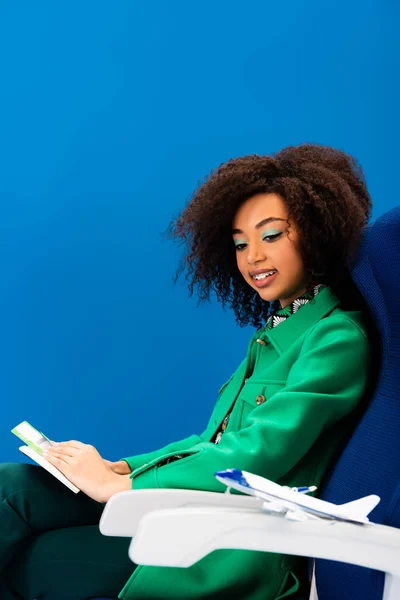 Smiling African American Woman Looking Model Plane Isolated Blue — Stock Photo, Image