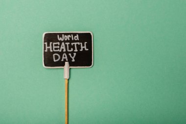 Top view of card with world health day lettering on green background clipart