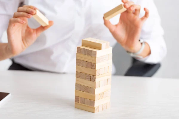 Cropped View Businesswoman Stacking Wooden Building Blocks Table Grey Background — Stock Photo, Image