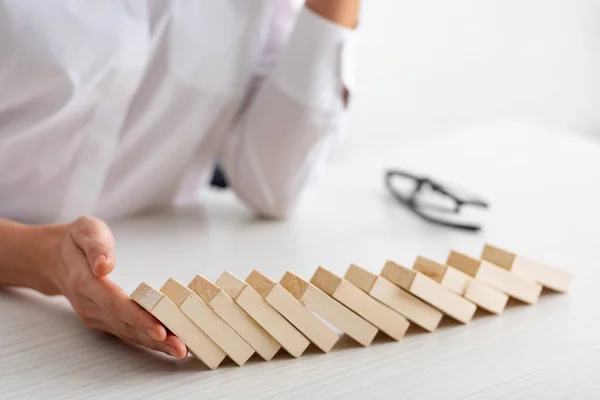 Cropped View Businesswoman Holding Falling Building Blocks Table White Background — Stock Photo, Image