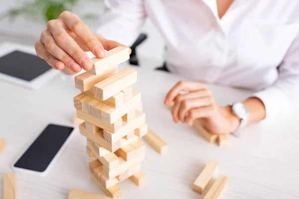 Selective focus of businesswoman playing blocks wood tower game at table — Stock Image Selective Focus Businesswoman Playing Blocks Wood Tower Game Table Stock Picture