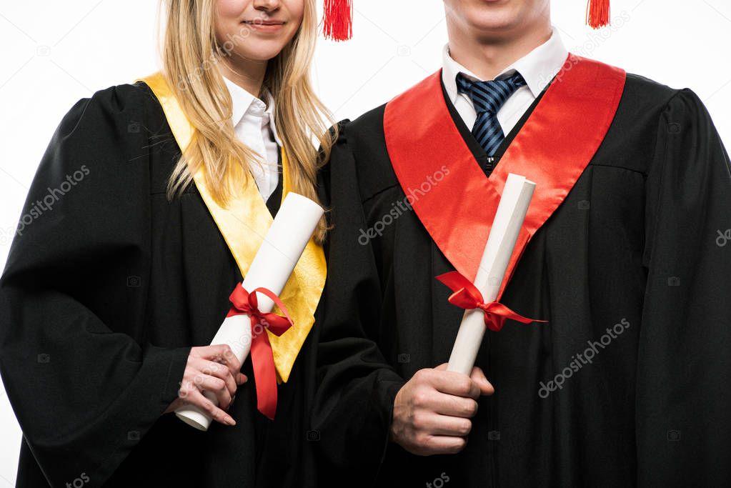 Front view of students holding diplomas isolated on white