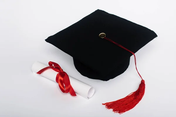 Black Graduation Cap Red Tassel Diploma Bow White Background — Stock Photo, Image