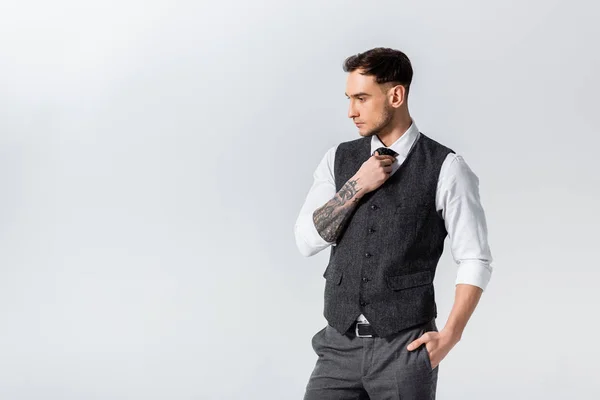 Handsome Tattooed Elegant Bridegroom Adjusting Tie Isolated Grey — Stock Photo, Image