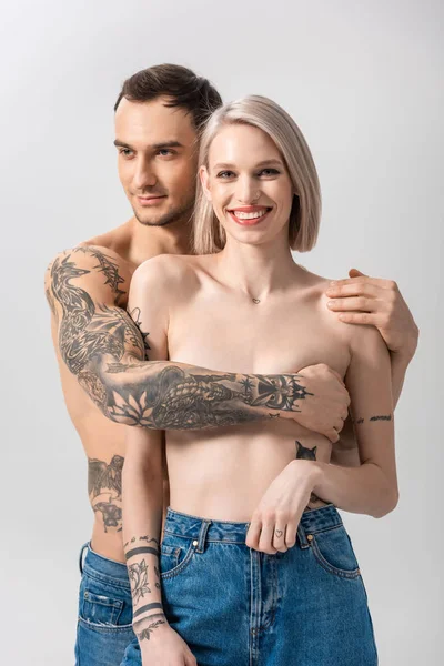 Happy Young Shirtless Tattooed Couple Jeans Hugging Isolated Grey — Stock Photo, Image