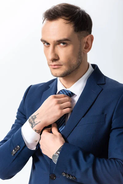 Successful Tattooed Young Businessman Blue Suit Adjusting Tie Isolated White — Stock Photo, Image