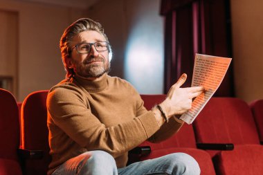emotional stage director showing scenario in theater clipart