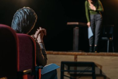 selective focus of theater director applauding to professional actress on stage clipart