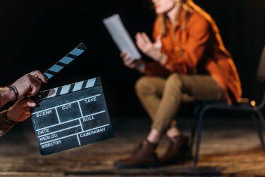 selective focus of actor with clapboard in front  clipart