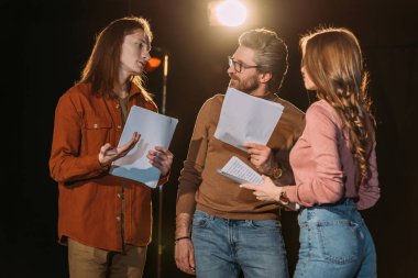 young actor and actress on rehearse with mature theater director clipart