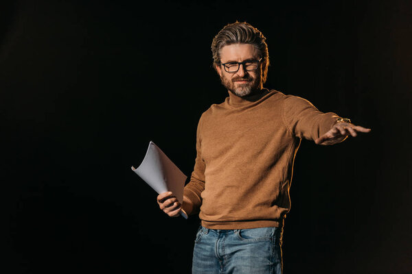 theater director holding scenario isolated on black