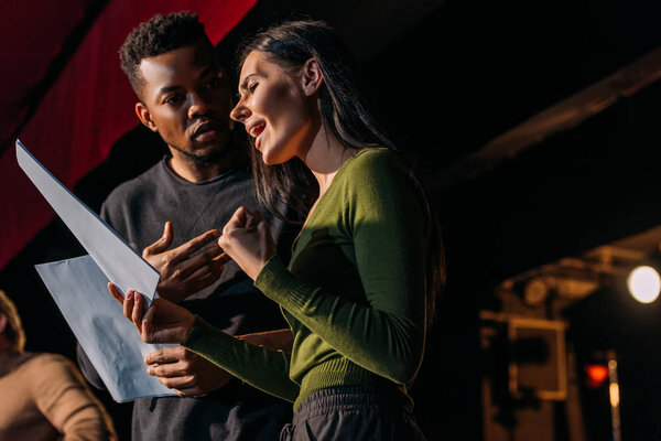multiethnic actor and actress having rehearse on stage in theater
