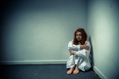 demonic evil girl in nightgown standing near wall clipart