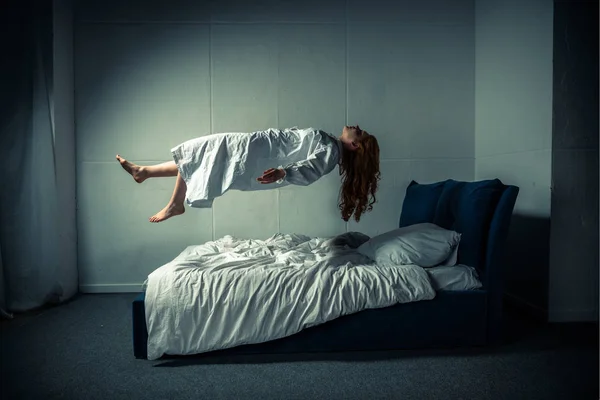 Yatağın Üzerinde Yükselen Gecelikli Şeytani Kız — Stok fotoğraf