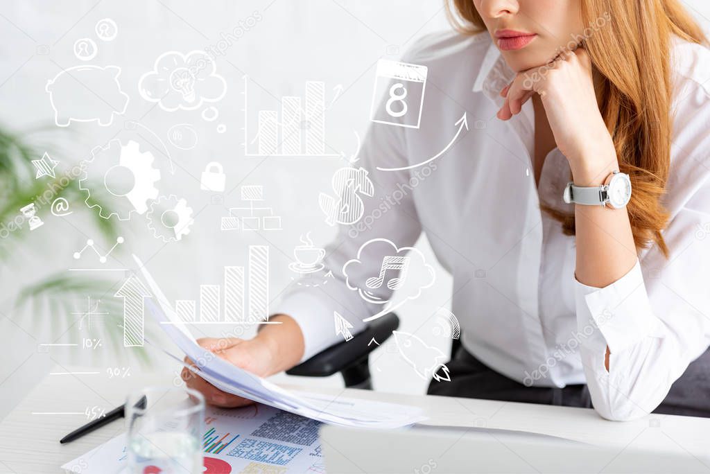 Cropped view of businesswoman holding dossier near graphs and laptop on table, business illustration