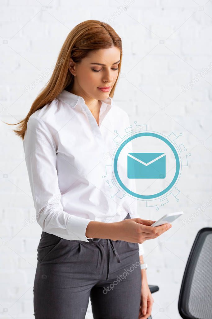 Attractive businesswoman using smartphone in office, email illustration