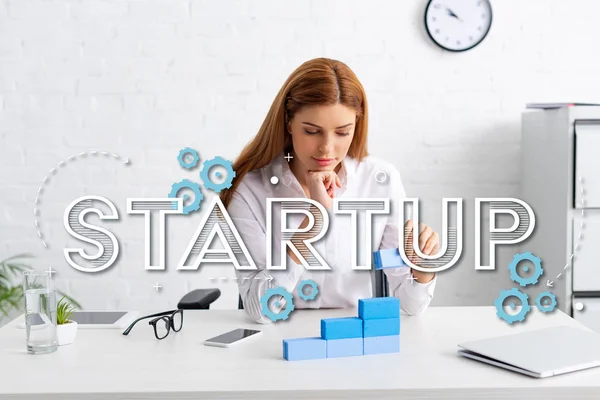 Attractive businesswoman stacking marketing pyramid from blue building blocks on table, startup illustration — Stock Image Attractive Businesswoman Stacking Marketing Pyramid Blue Building Blocks Table Startup Stock Image