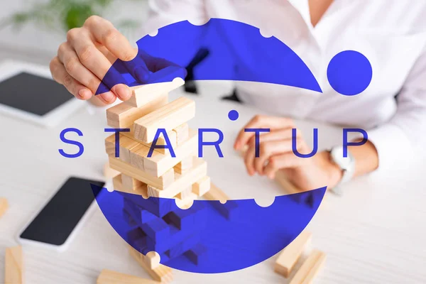 Selective focus of businesswoman playing blocks wood tower game at table, startup illustration — Stock Image Selective Focus Businesswoman Playing Blocks Wood Tower Game Table Startup Royalty Free Stock Photos