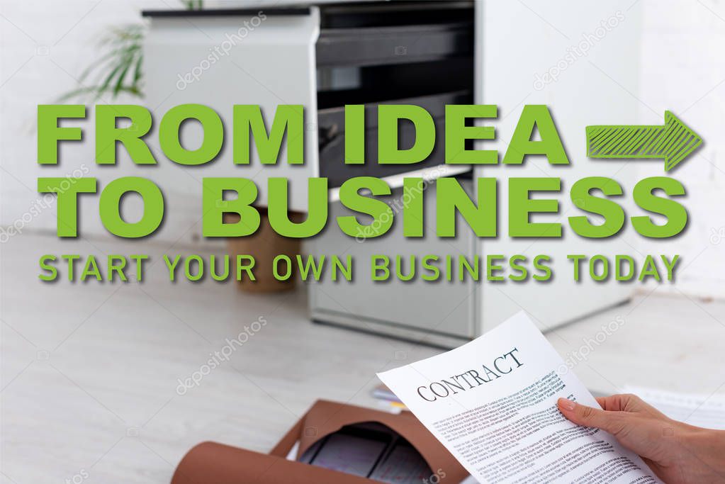 Cropped view of businesswoman holding contract near paper folders on floor, from idea to business illustration