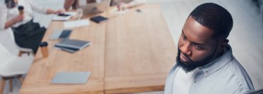 panoramic shot of african american businessman looking away  clipart